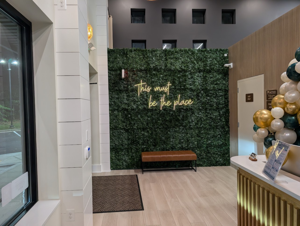 The Reserve Pasadena MD reception area with living green wall and neon sign